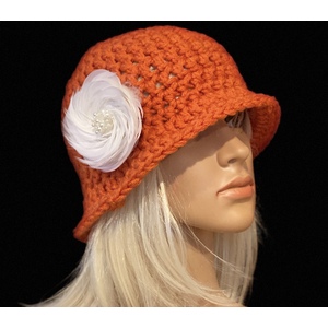  Women’s tangerine cloche hat with a white feather brooch by Sherri Gold