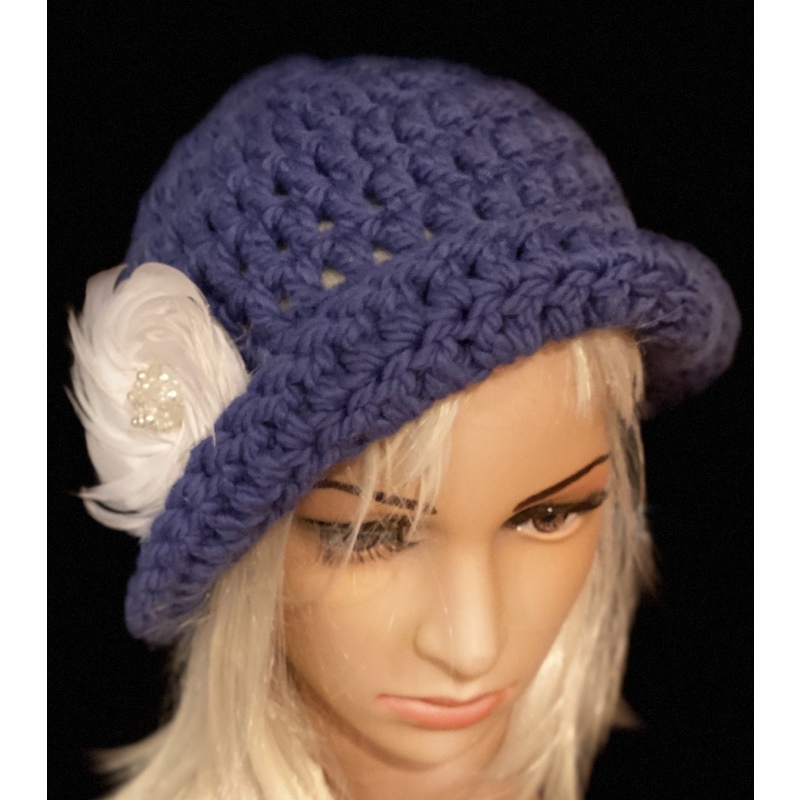 Women’s royal blue floppy hat with a white feather brooch. by Sherri Gold