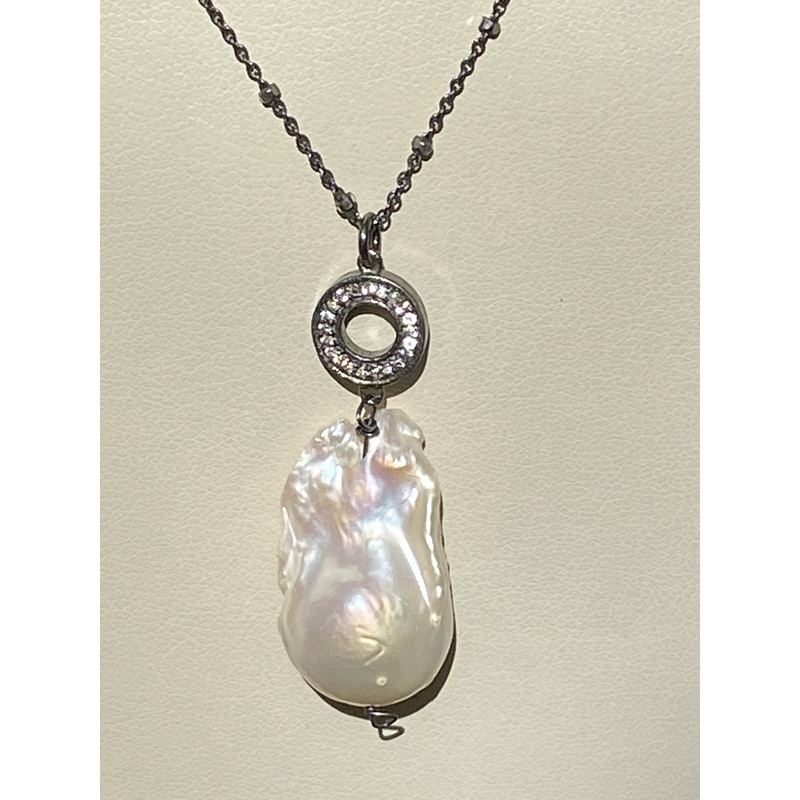 Baroque pearl suspended from blackened silver ball chain by Barbara  Weinreb