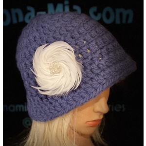 Women’s royal blue floppy hat with a white feather brooch. by Sherri Gold
